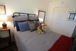 Full size bed in one guest bedroom on second level